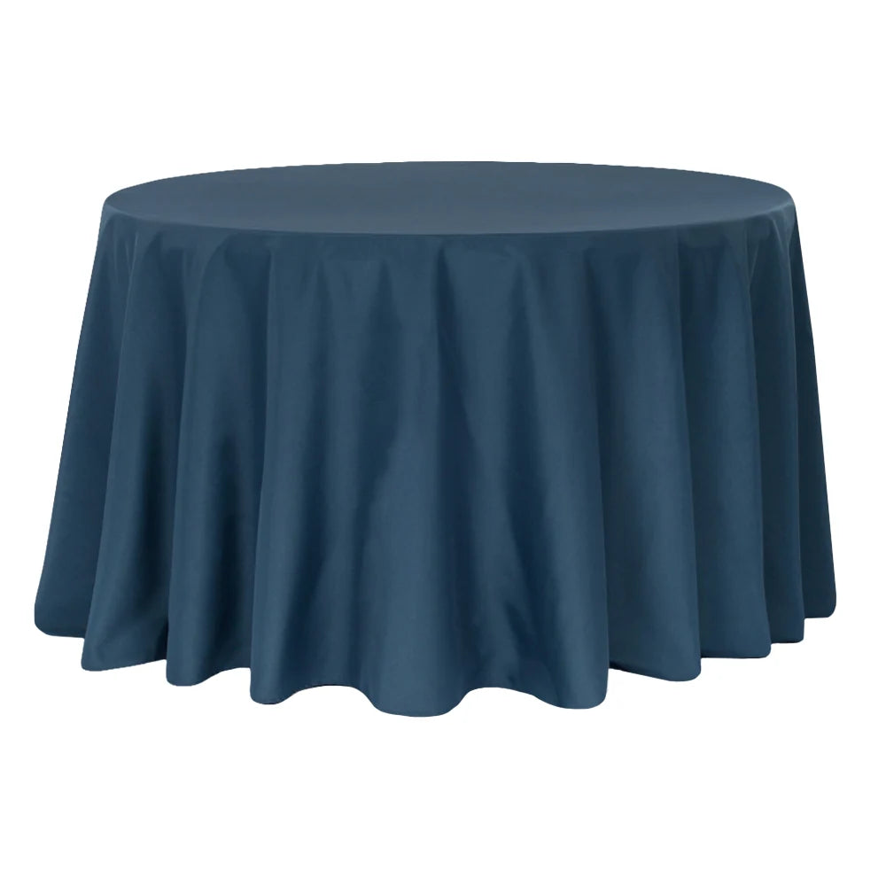 Round table covered with a navy blue tablecloth on a white background