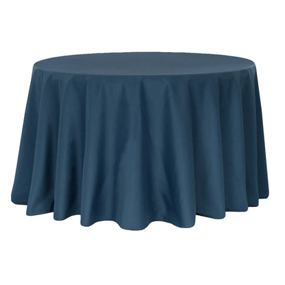 Round table covered with a navy blue tablecloth on a white background